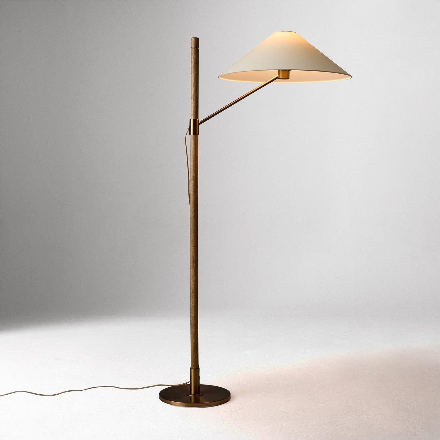 Decor your interior with the Devon Floor Lamp (64"), a refined fusion of antique brass, warm ash wood, and delicate paper. Designed for both residential and contract-grade commercial settings, it offers elegance, durability, and ambient lighting in one striking piece.